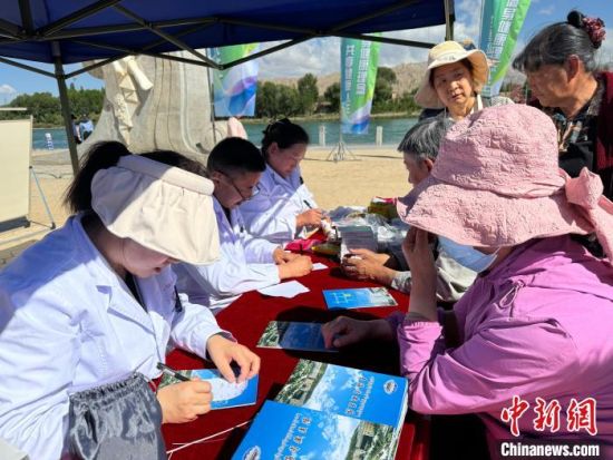 图为医务人员为民众答疑解惑。祁绣娟摄